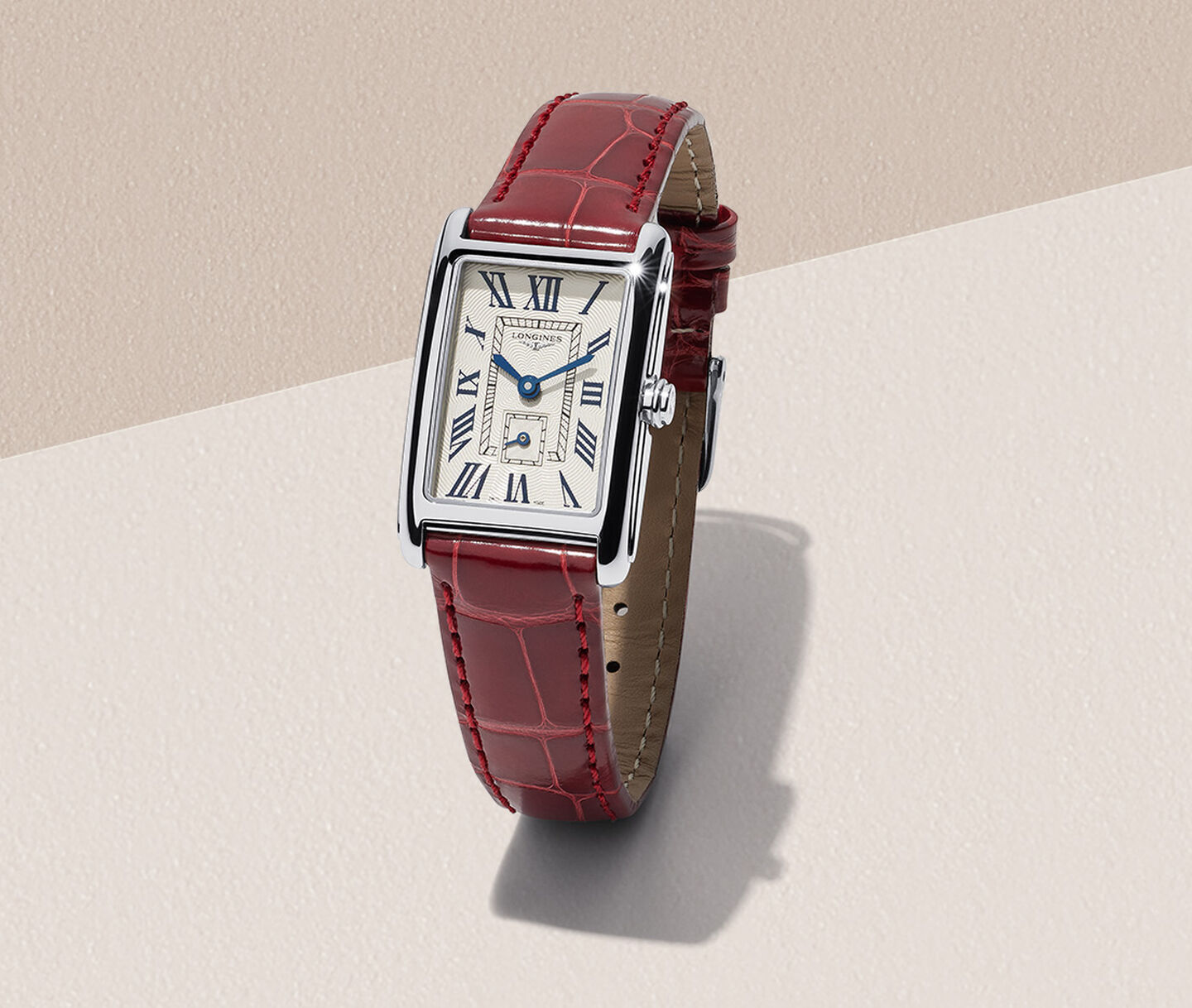 Longines DolceVita watch for women on a beige background.